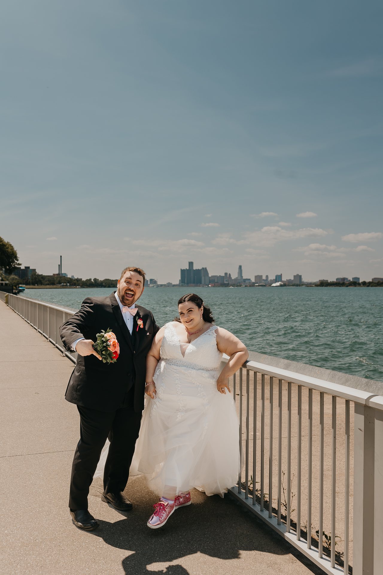 Chelsie and Greg posing playfully by the water