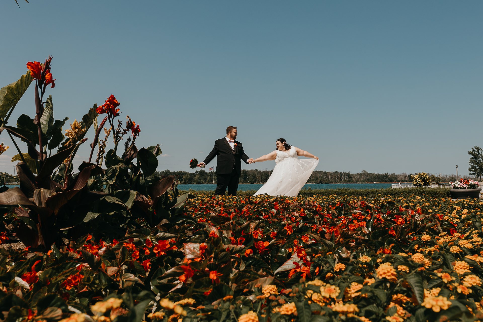 Chelsie and Greg walking through the flower garden