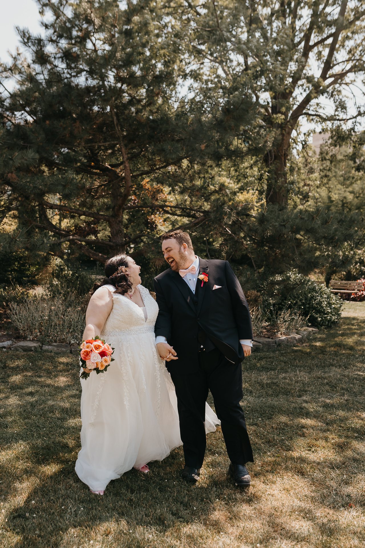 Chelsie and Greg laughing together beneath the trees