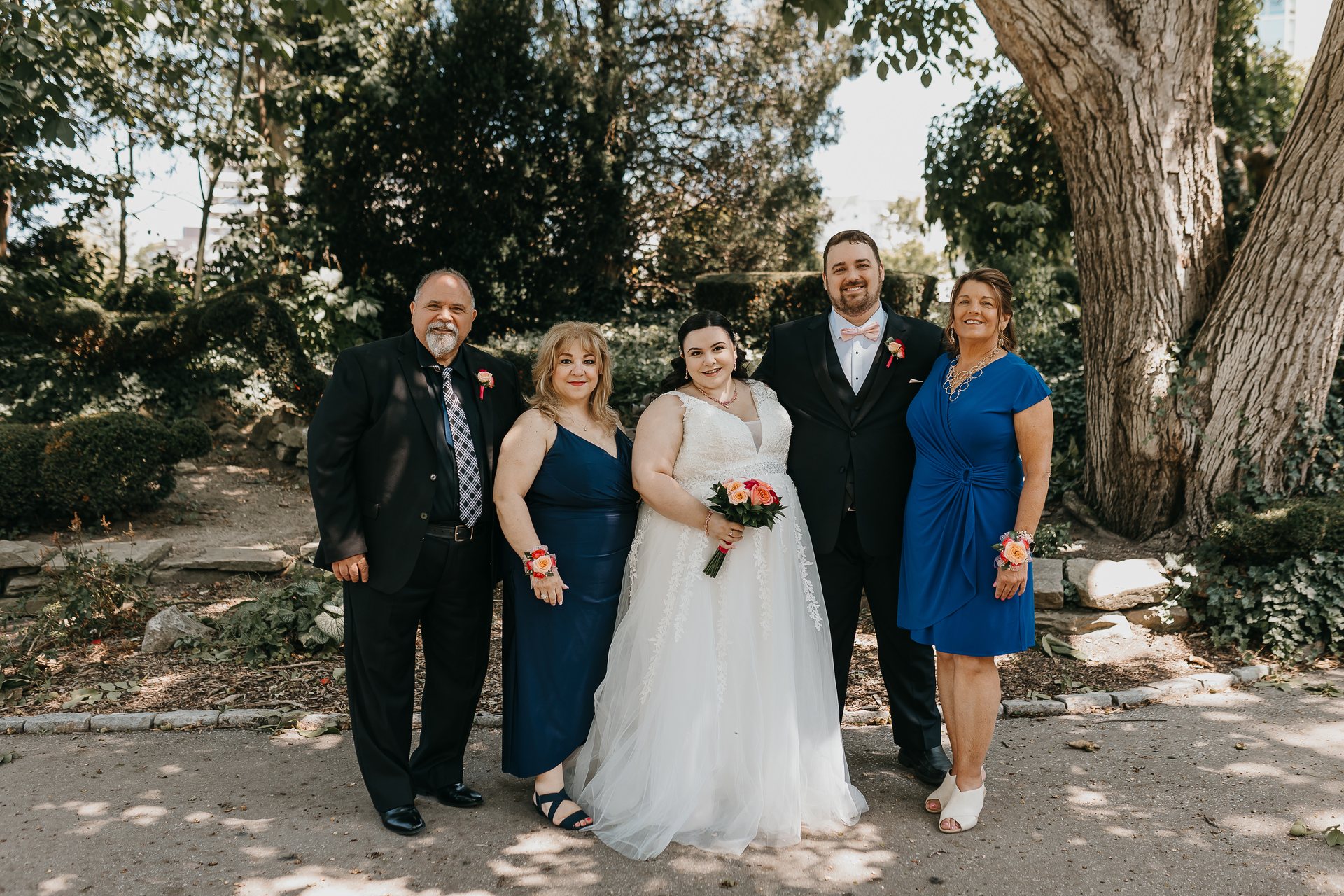 Chelsie and Greg posing with their parents
