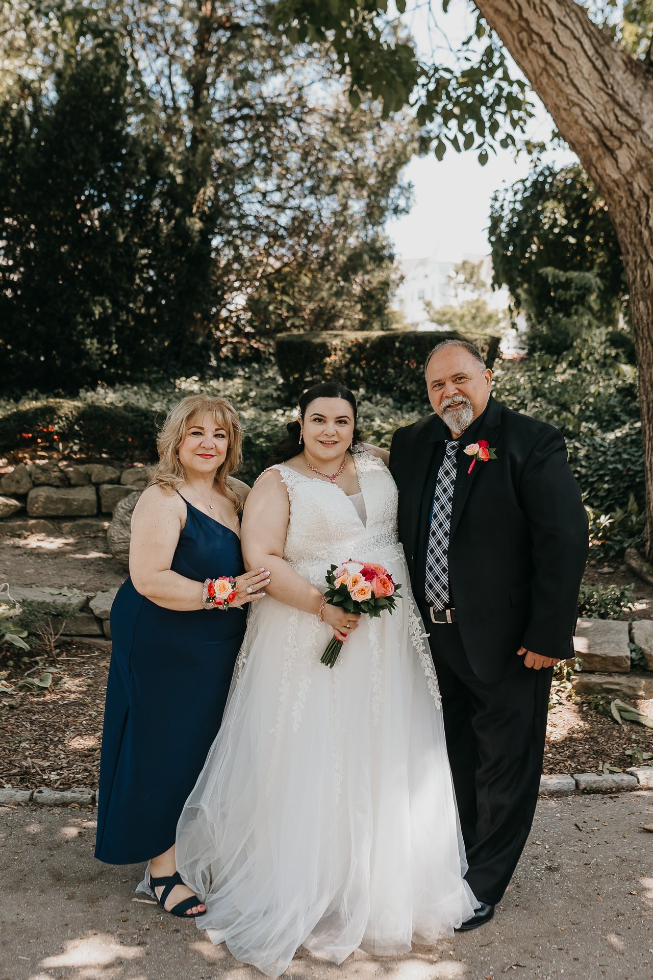 Chelsie posing with two family members