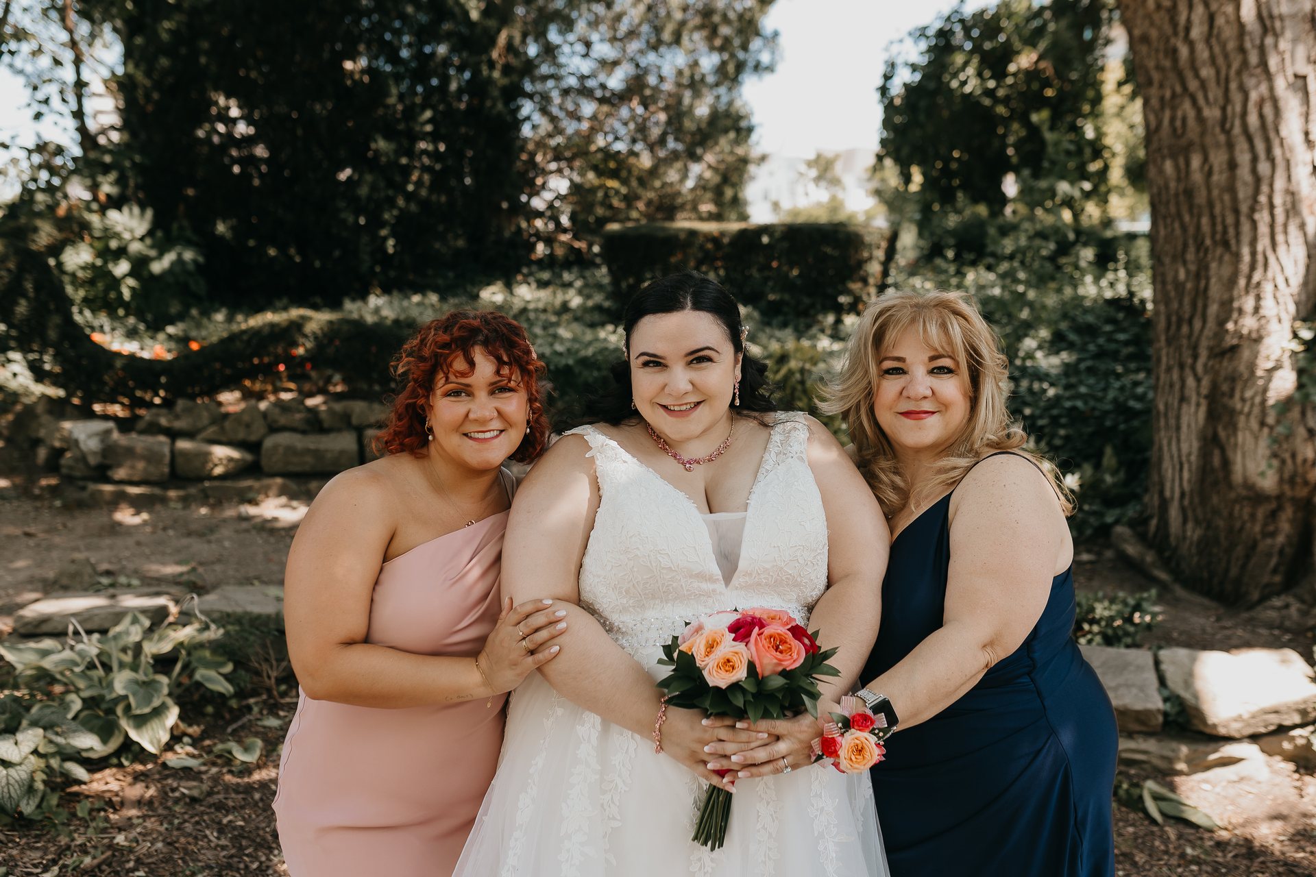 Chelsie posing with two family members in the garden