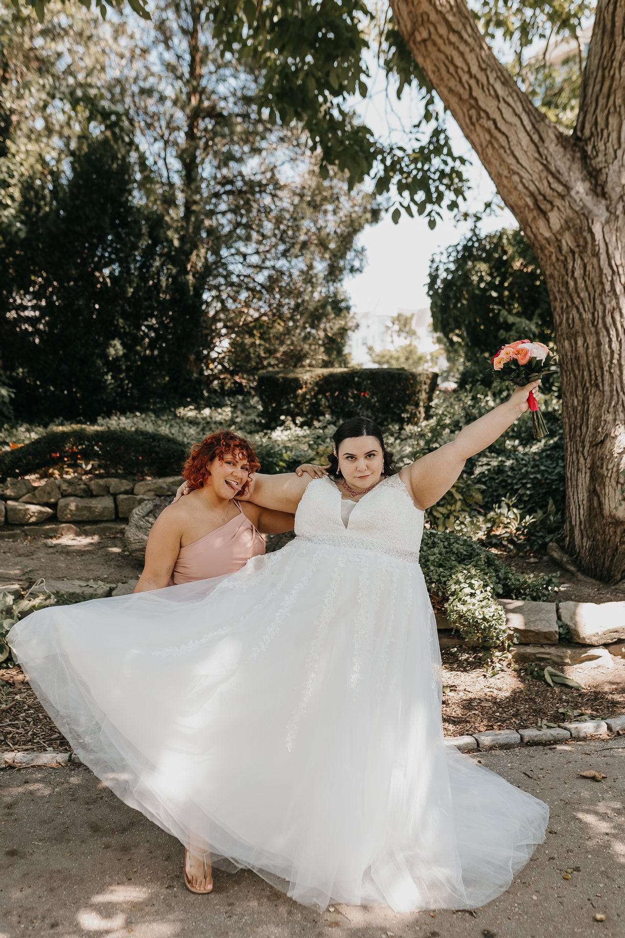 Chelsie celebrating with a family member while holding her bouquet
