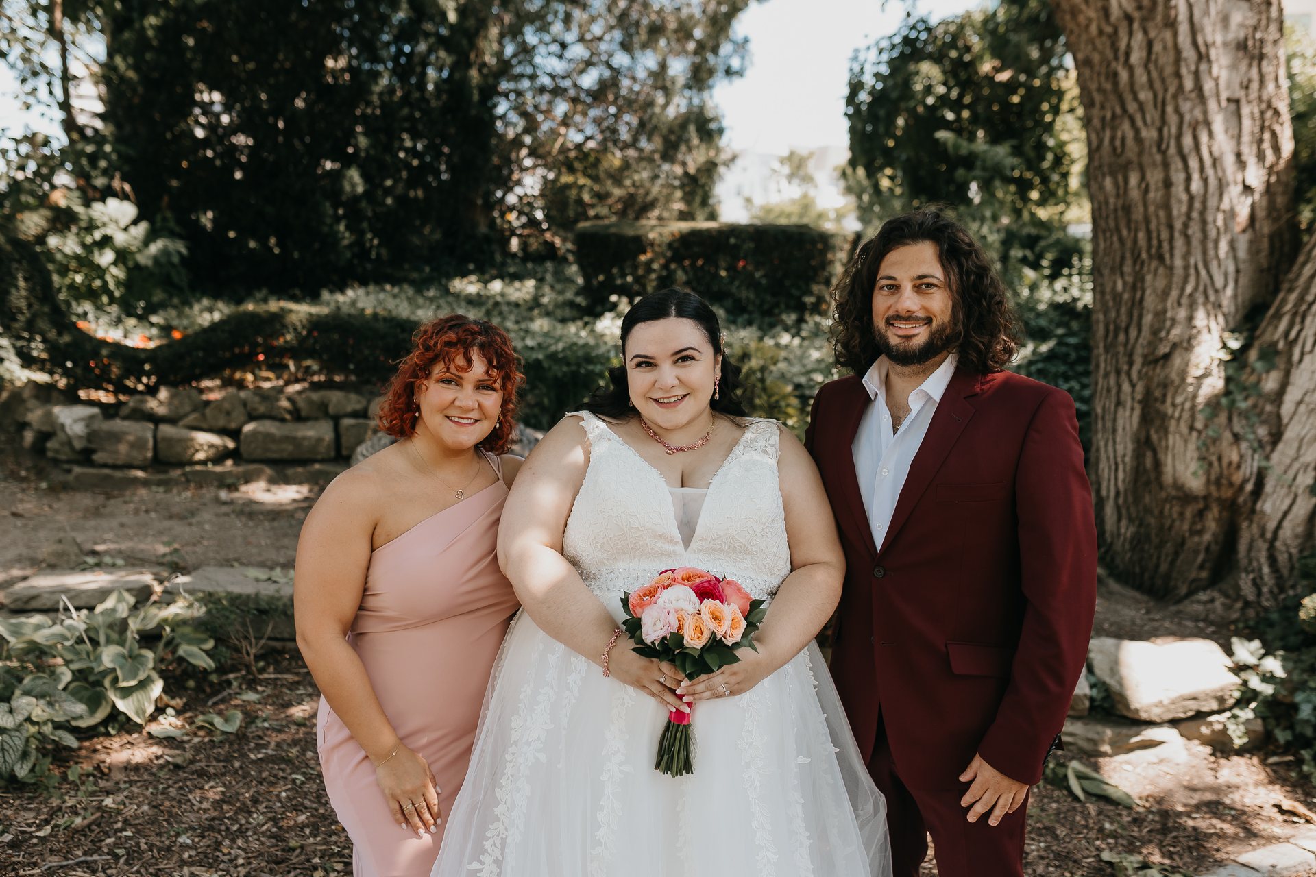 Chelsie posing with two members of the wedding party