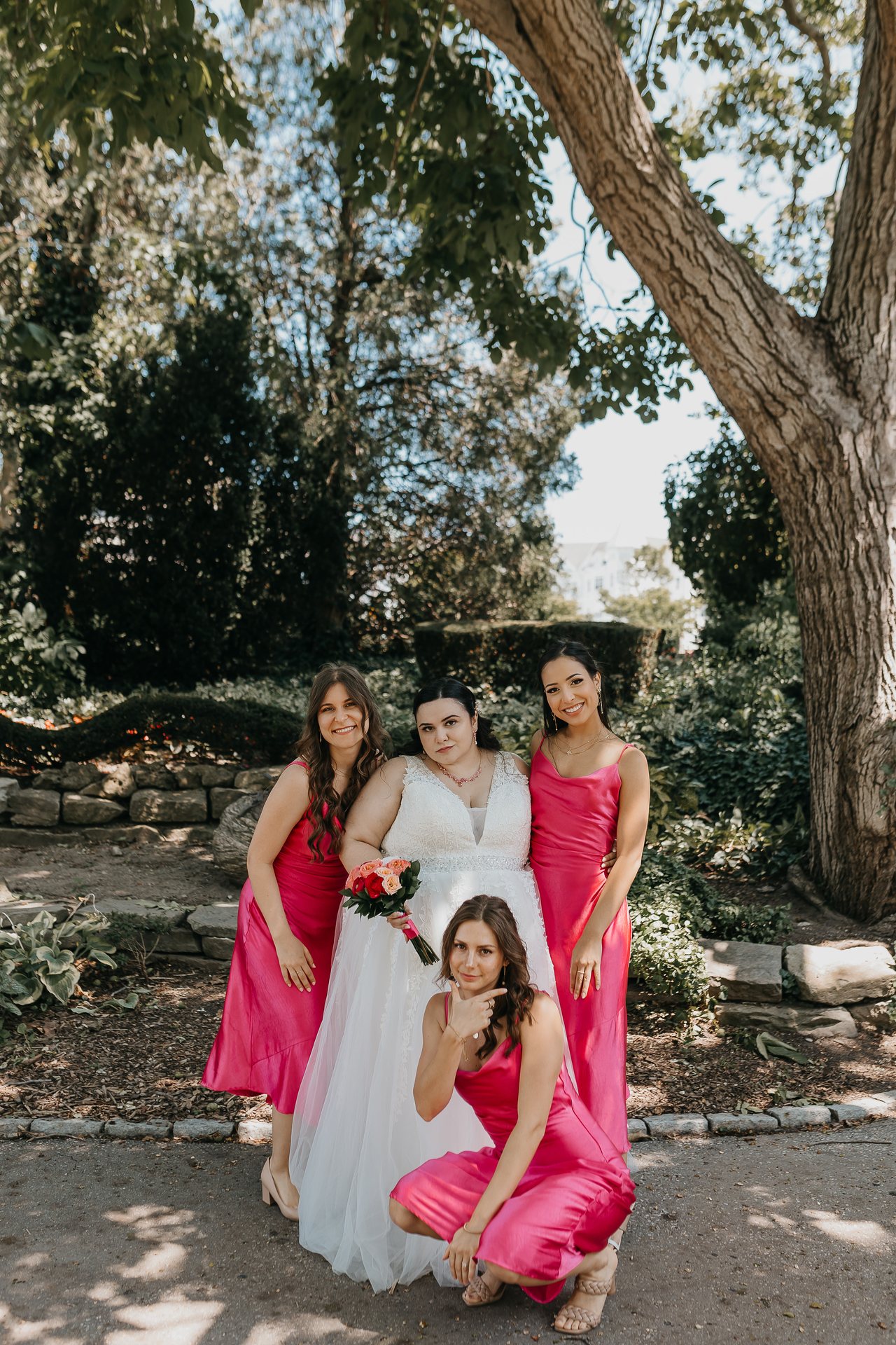 Chelsie posing with three members of the wedding party