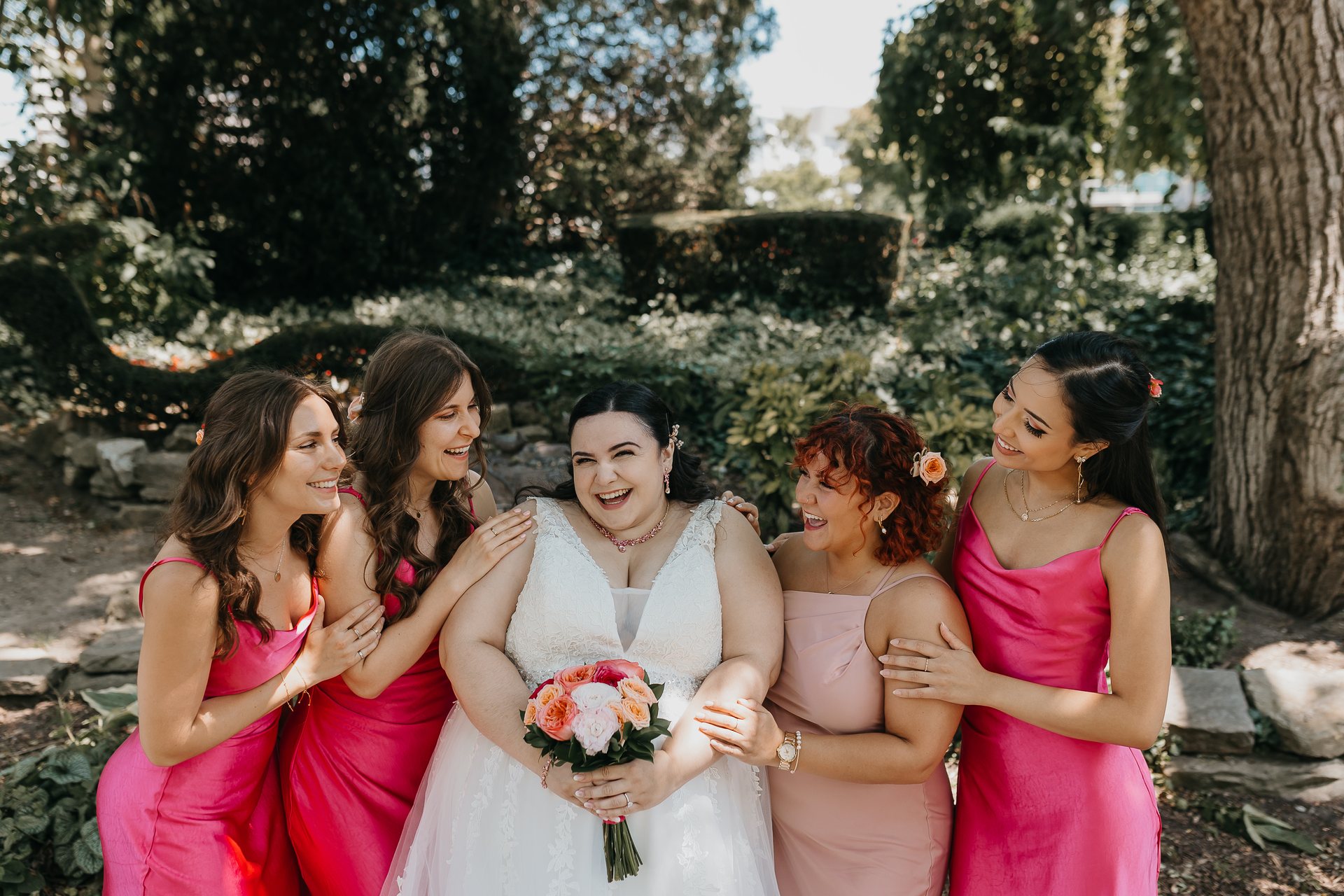 Chelsie laughing with four members of the wedding party