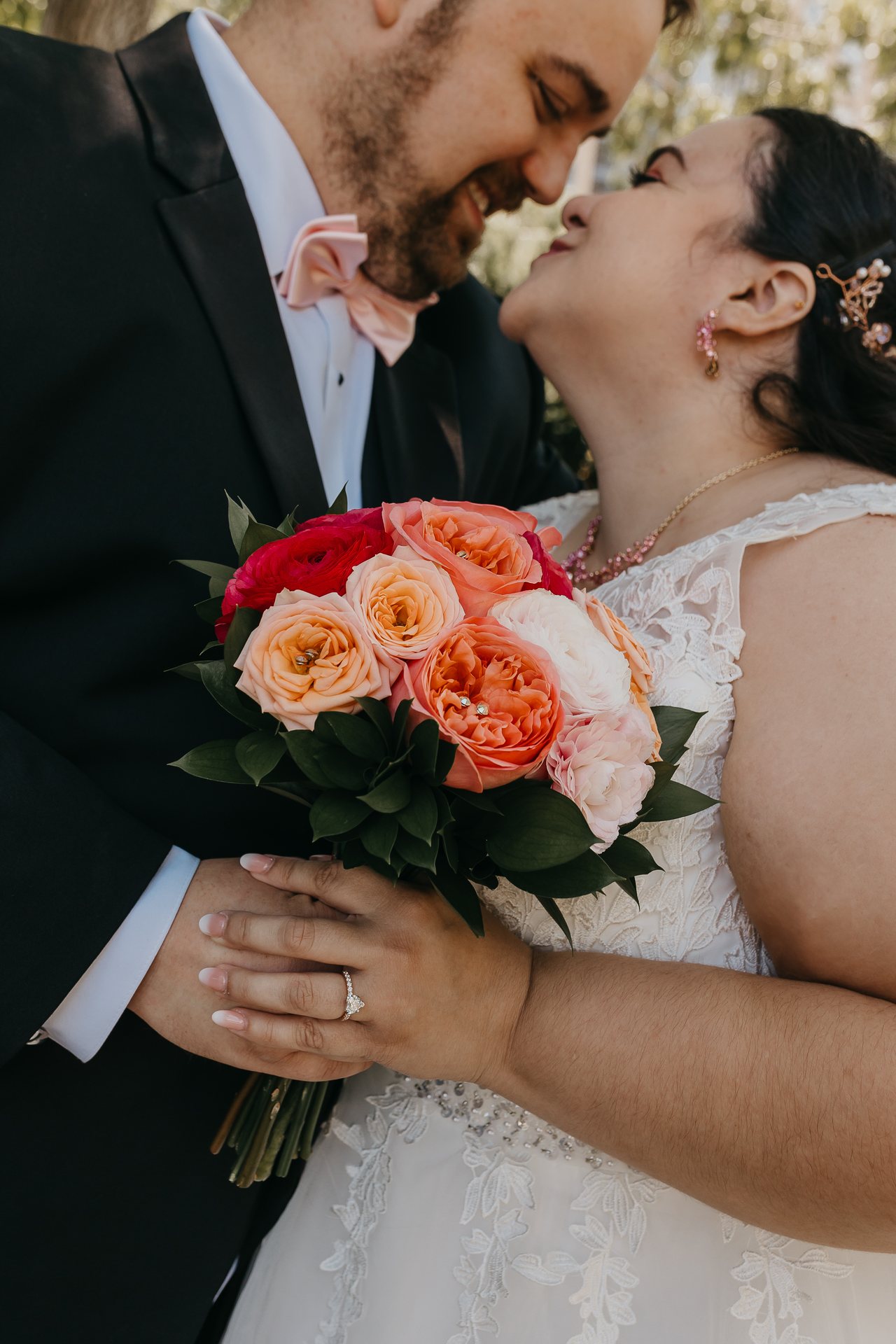 Chelsie and Greg kissing behind Chelsie's bouquet