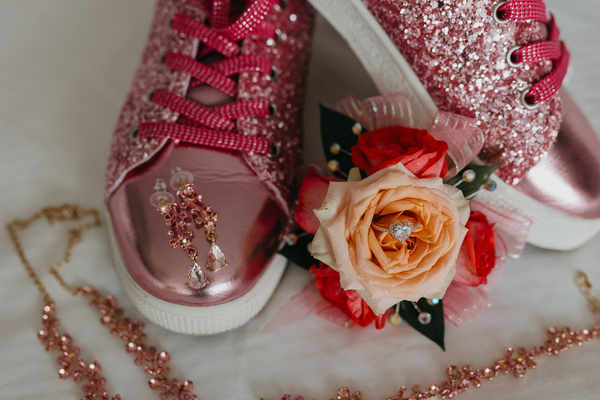 Pink wedding shoes, jewelry, flowers, and an engagement ring