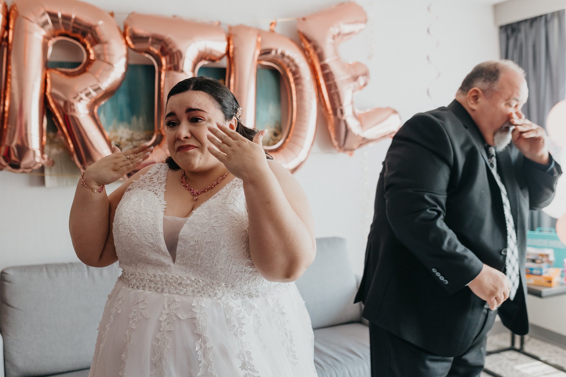 Chelsie wiping happy tears while Greg stands nearby