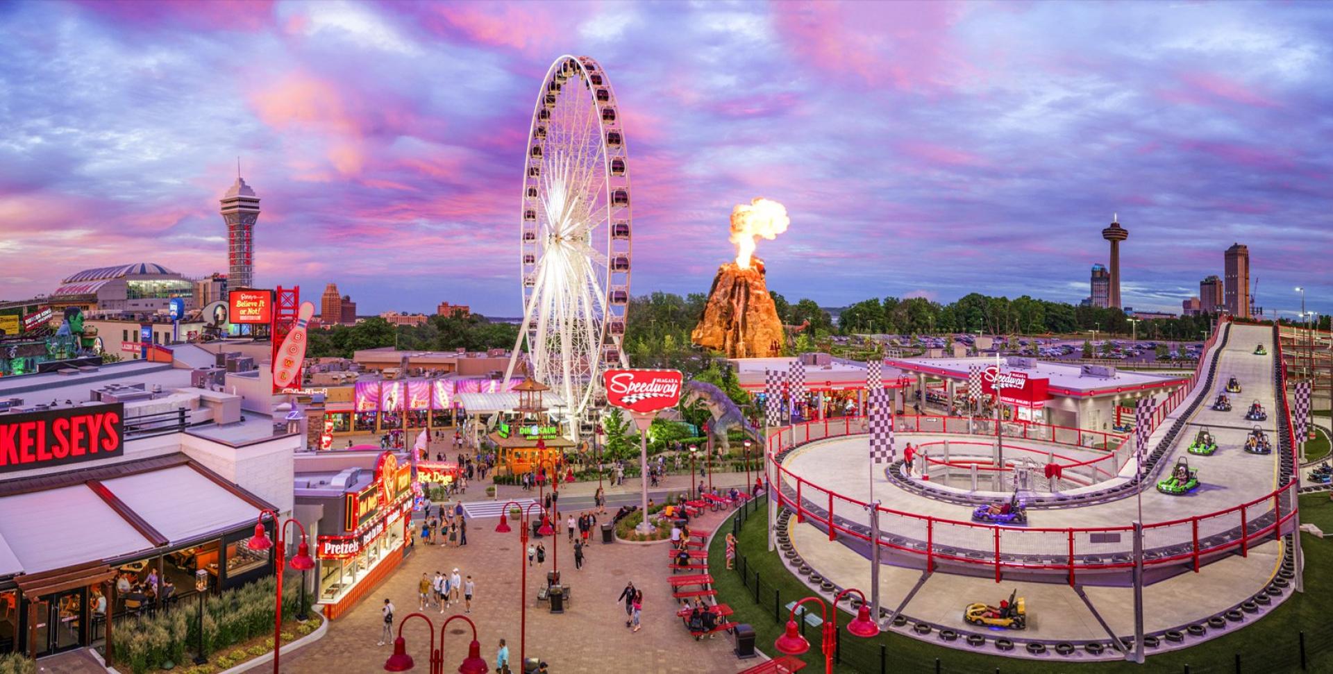 Niagara SkyWheel and colourful Clifton Hill attractions at dusk